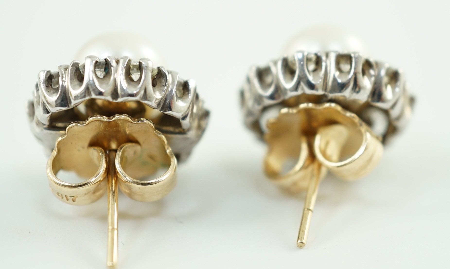 A pair of white gold? cultured pearl and diamond cluster set circular earrings